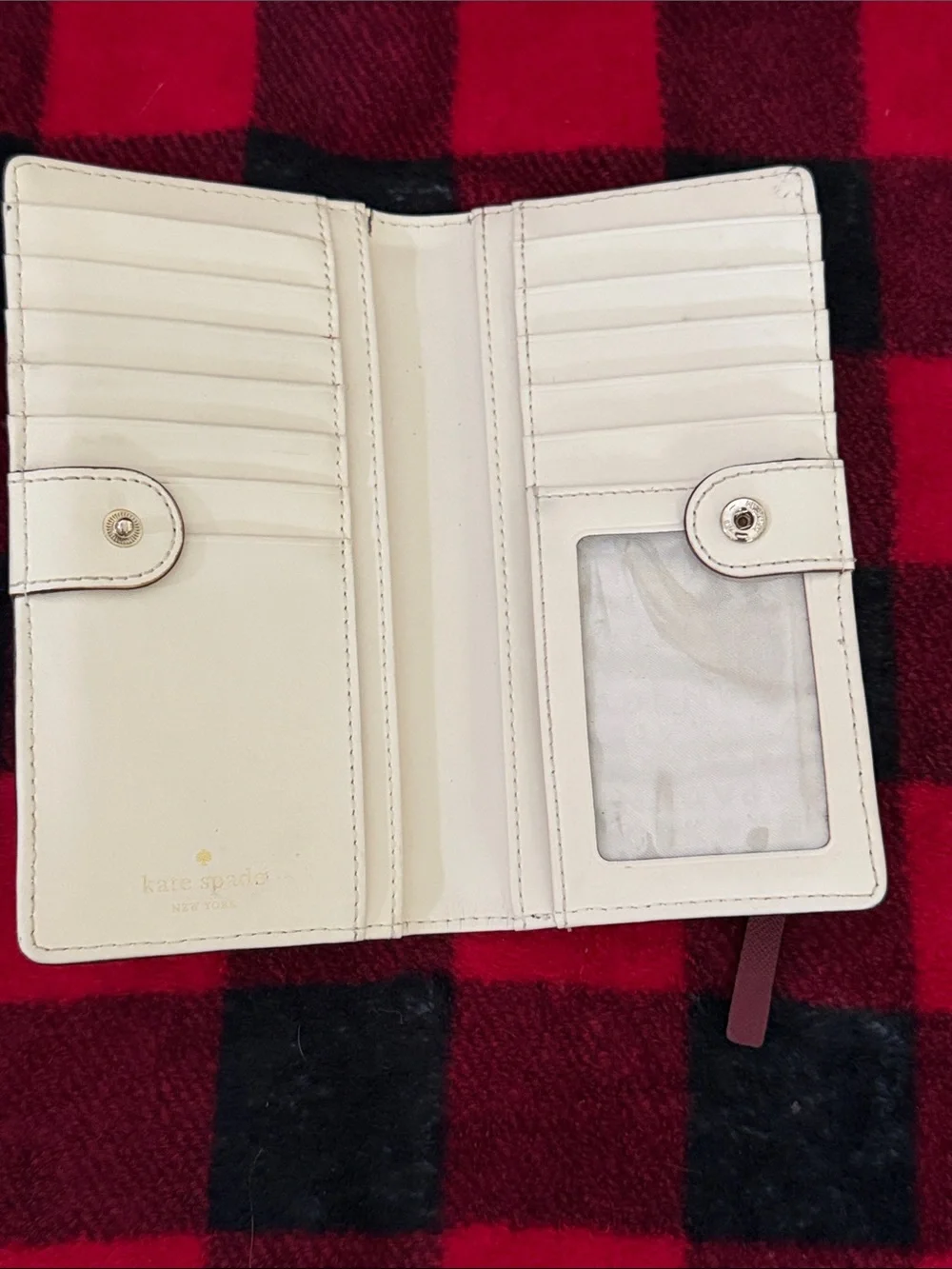 Kate Spade New York Staci large slim bifold wallet in a red currant shade